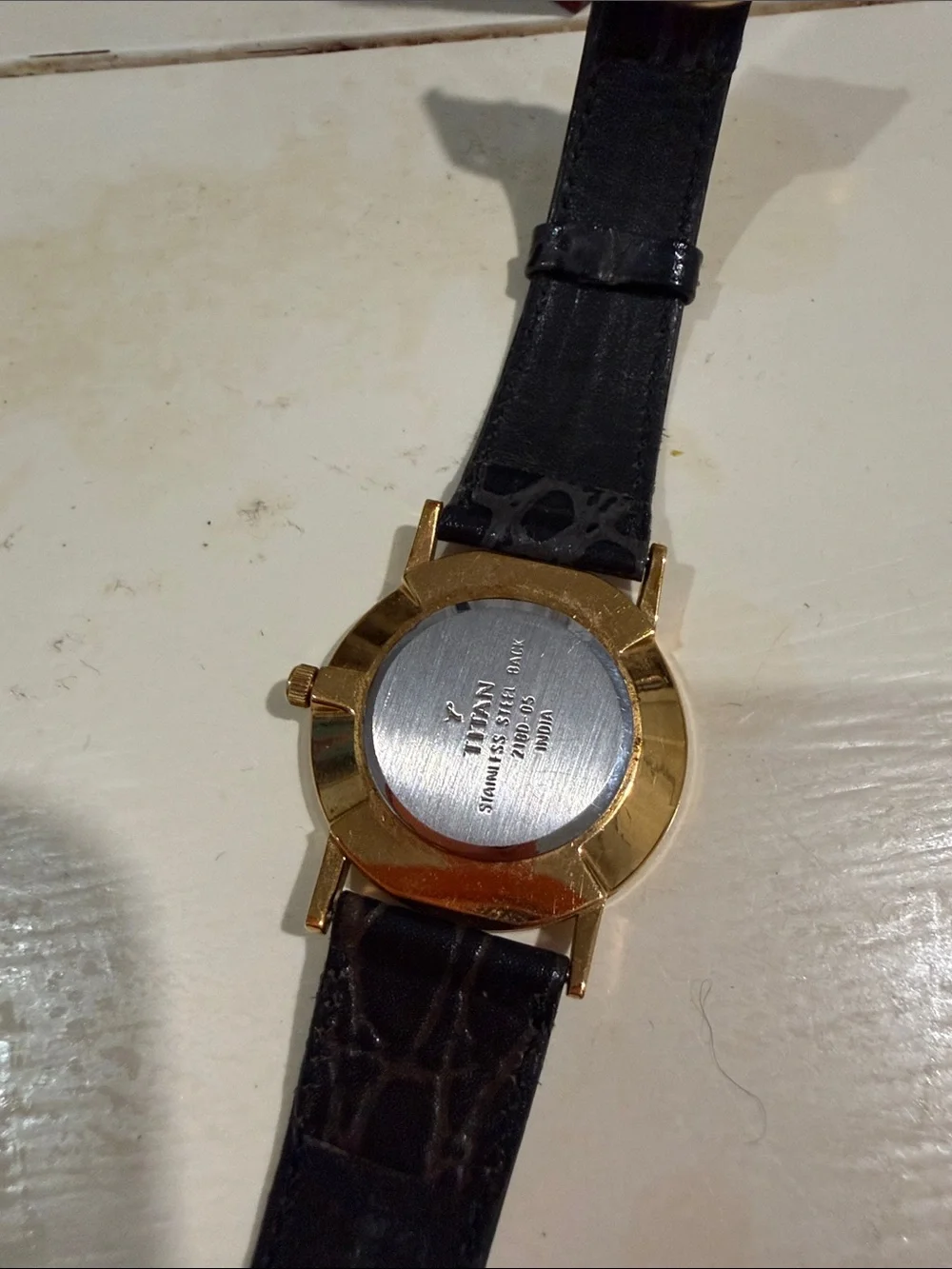 Titan Black Dial Watch with Gold-Tone Case and Black Patterned Strap